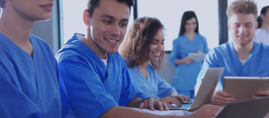 Group of smart medical students with gadgets in college